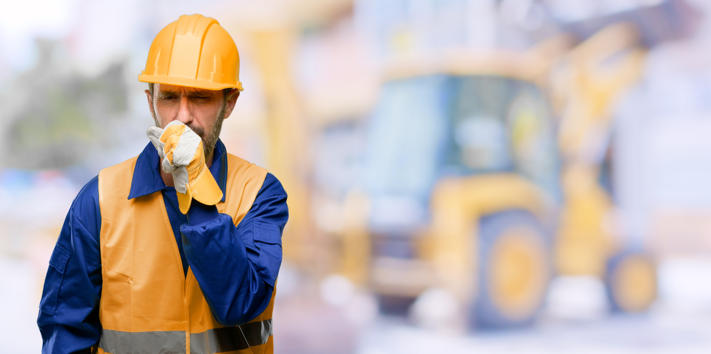Senior engineer man, construction worker sick and coughing, suffering asthma or bronchitis, medicine concept Coughing construction worker in blue shirt, yellow vest, and hard hat